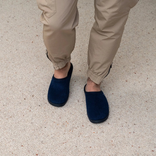 Man wearing DrLuigi® navy blue cotton medical slippers, standing view