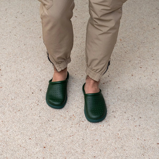 Man wearing DrLuigi® green leather orthopedic clogs, standing view