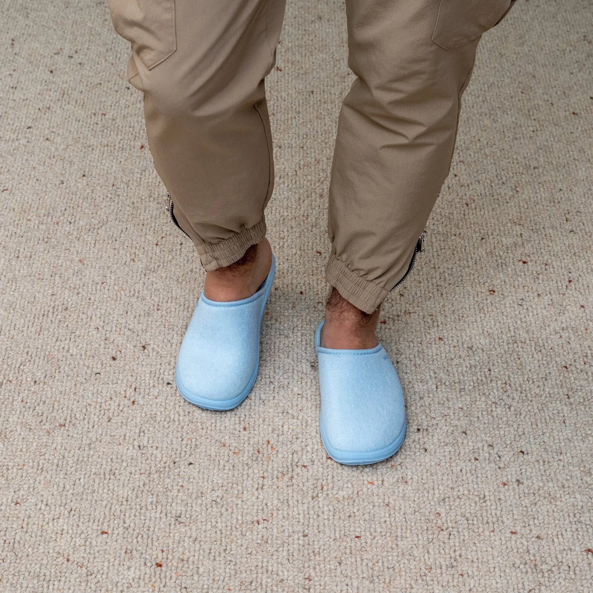 Man wearing DrLuigi® baby blue cotton medical slippers, standing view