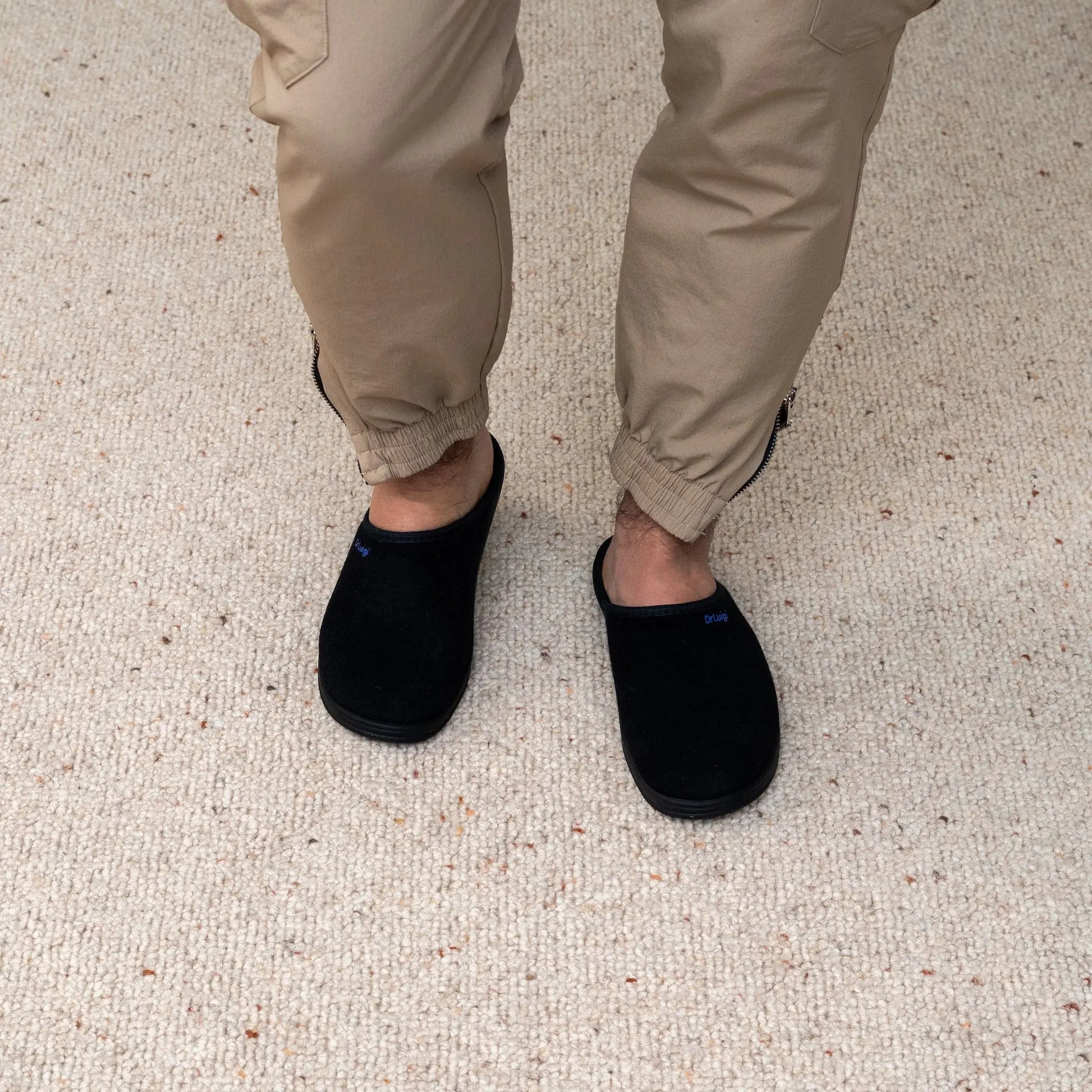 Man wearing DrLuigi® black cotton medical slippers, standing view