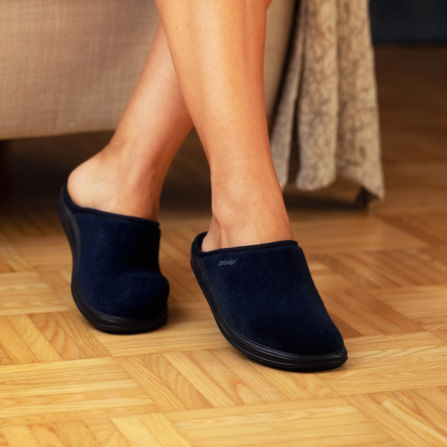 Woman wearing DrLuigi® navy blue cotton medical slippers, lifestyle view
